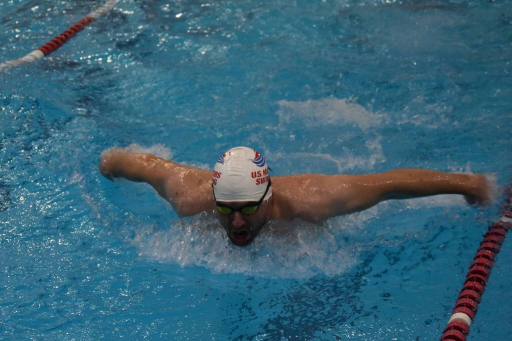 Lucas Petersen swims the butterfly during a Top of the World Swimming practice on Wednesday, Dec. 14, 2022, at Kenai Central High School in Kenai, Alaska. (Jake Dye/Peninsula Clarion)