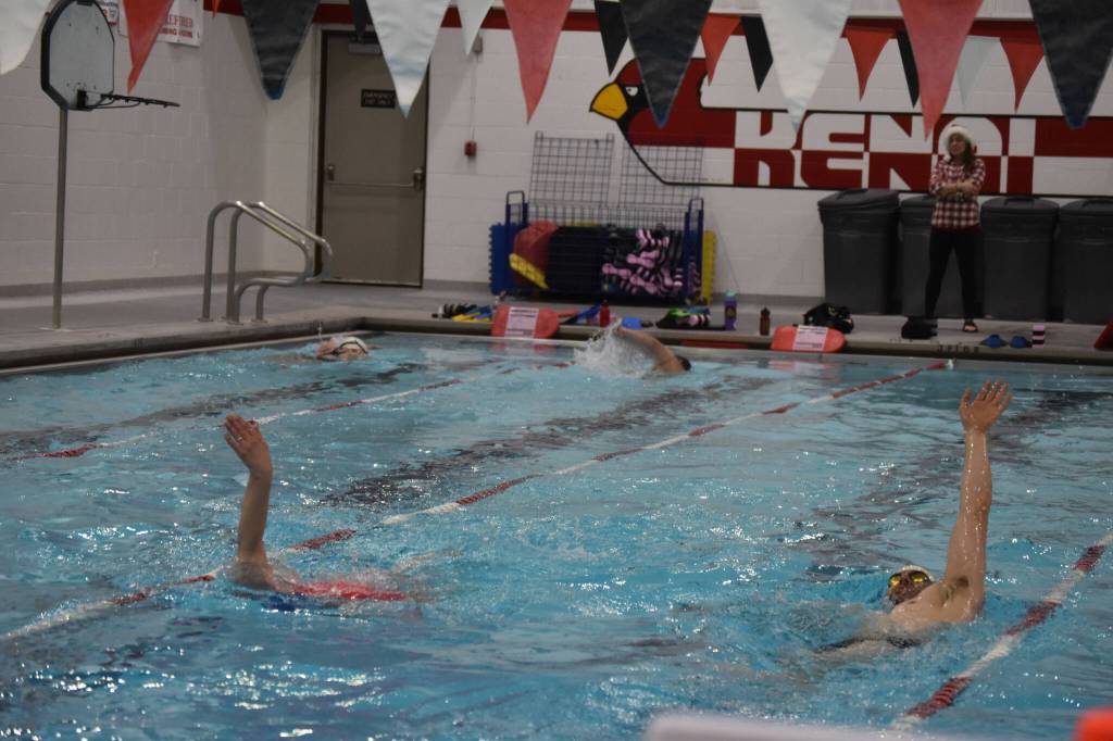 Coach Angie Brennan watches as swimmers complete a workout set during a Top of the World Swimming practice on Wednesday, Dec. 14, 2022, at Kenai Central High School in Kenai, Alaska. (Jake Dye/Peninsula Clarion)