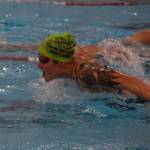 Kendra Ashwell swims the butterfly during a Top of the World Swimming practice on Wednesday, Dec. 14, 2022, at Kenai Central High School in Kenai, Alaska. (Jake Dye/Peninsula Clarion)