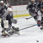 Soldotna goalie Jackson Purcell steers the puck wide of the net and Kenai Centrals Logan Mese on Thursday, Dec. 15, 2022, at the Kenai Multi-Purpose Facility in Kenai, Alaska. (Photo by Jeff Helminiak/Peninsula Clarion)