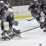 Soldotna goalie Jackson Purcell steers the puck wide of the net and Kenai Central's Logan Mese on Thursday, Dec. 15, 2022, at the Kenai Multi-Purpose Facility in Kenai, Alaska. (Photo by Jeff Helminiak/Peninsula Clarion)