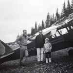 Photo courtesy of Ben and Marian Goble 
Ben, Marian and Grace Goble pose next to Bens airplane on the beach near Kenai in 1959.