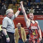 Kenai Centrals Andrew Gaethle celebrates winning a Division II state title at 152 pounds as Kardinals head coach Jason Chavarria looks on Saturday, Dec. 18, 2022, at the state wrestling tournament at the Alaska Airlines Center in Anchorage, Alaska. (Photo by Jeff Helminiak/Peninsula Clarion)
