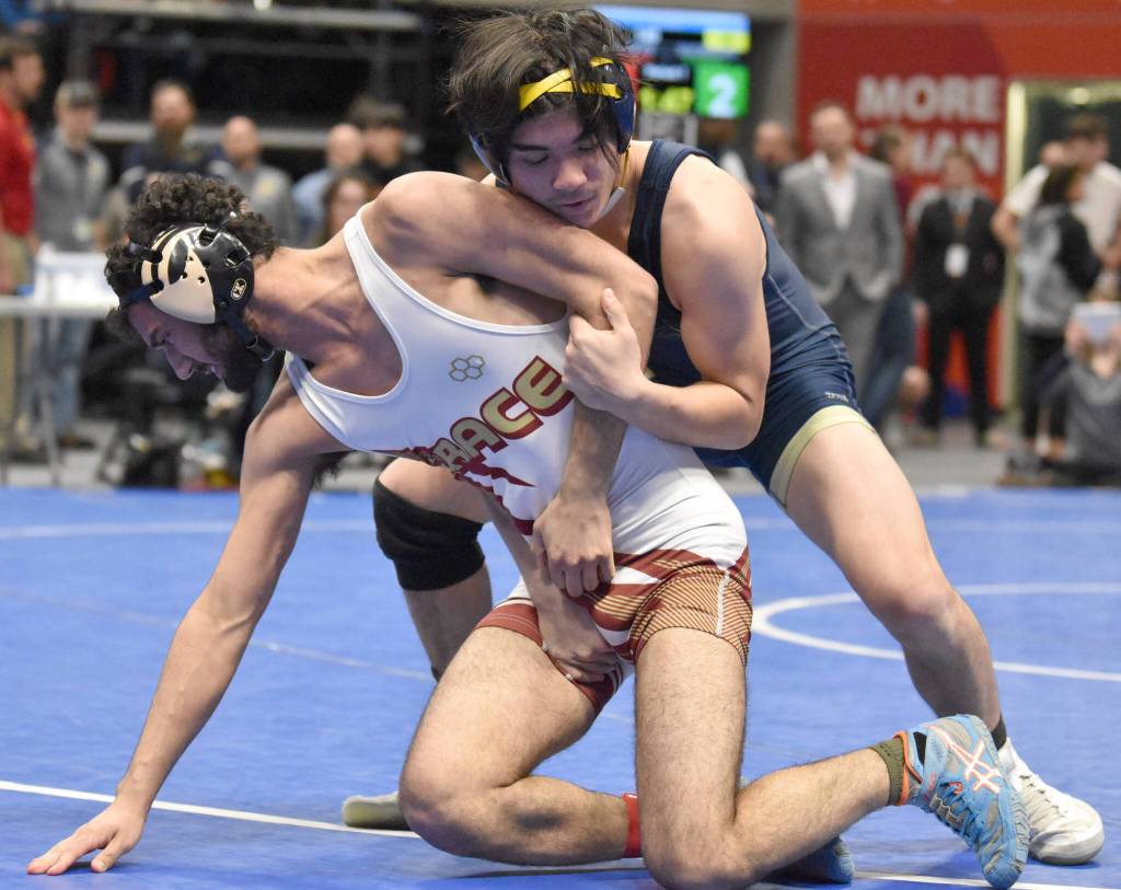 Homers Russell Nyvall defeats Grace Christians Josh Paulson for the Division II state title at 140 pounds Saturday, Dec. 18, 2022, at the state wrestling tournament at the Alaska Airlines Center in Anchorage, Alaska. (Photo by Jeff Helminiak/Peninsula Clarion)
