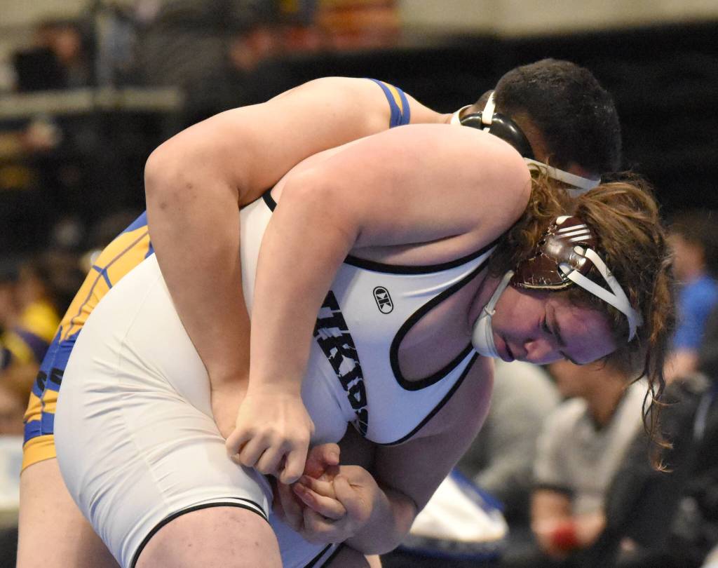 Nikiskis Mayaac Schmit scores an escape on Barrows Uatahouse Tuifua before losing the Division II state title match Saturday, Dec. 18, 2022, at the state wrestling tournament at the Alaska Airlines Center in Anchorage, Alaska. (Photo by Jeff Helminiak/Peninsula Clarion)