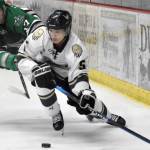 Kenai River Brown Bears forward Kotaro Tsutsumi protects the puck from Chippewa (Wisconsin) Steel forward Peyton Platter on Saturday, Oct. 29, 2022, at the Soldotna Regional Sports Complex in Soldotna, Alaska. (Photo by Jeff Helminiak/Peninsula Clarion)