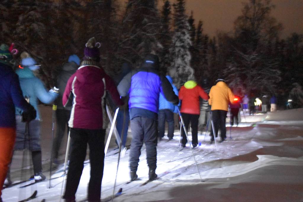 Skiiers take off down the trail during StarLight StarBright: A Winter Solstice Ski Event on Wednesday, Dec. 21, 2022 at the Kenai Golf Course in Kenai, Alaska.