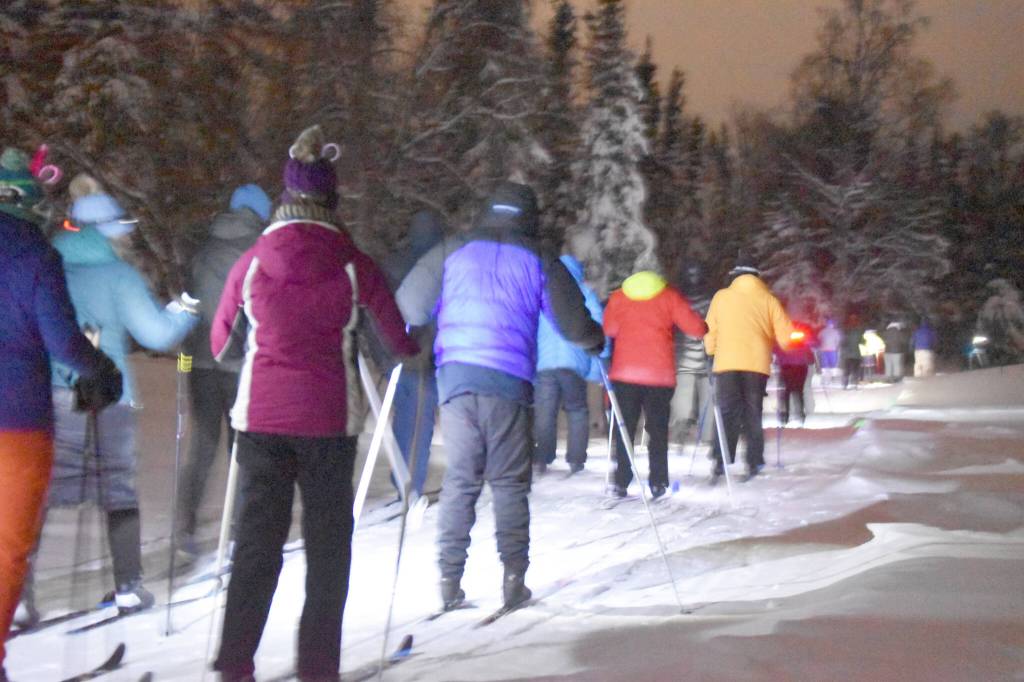 Jake Dye / Peninsula Clarion
Skiers take off down the trail during StarLight StarBright: A Winter Solstice Ski Event on Wednesday at the Kenai Golf Course.