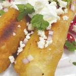 Adobo Chicken Floutas are topped with queso, sour cream, cilantro, onions and tomatoes. (Photo by Tressa Dale/Peninsula Clarion)