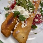 Adobo Chicken Floutas are topped with queso, sour cream, cilantro, onions and tomatoes. (Photo by Tressa Dale/Peninsula Clarion)