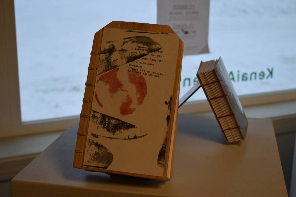 Two handmade journals rest on stands on Tuesday, Jan. 3, 2023, ahead of the opening of Diane Dunns 2000 Journals: Filling the Void at the Kenai Art Center in Kenai, Alaska. Dunn explained that this journal was special, a plea to her daughter. (Jake Dye/Peninsula Clarion)