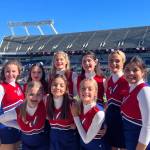 Members of the Kenai Central High School cheerleading team (back row, left to right): Kaitlyn Taylor, Sylvia McGraw, Malena Grieme, Maya Montague, Cali Holmes and Genesis Trevino; (front row, left to right): Makenzie Harden, Ella Romero and Brooklyn Reed stand for a photo at the Cheez-It Citrus Bowl on Monday, Jan. 1, 2023, at Camping World Stadium in Orlando, Florida. (Photo courtesy Brianna Force)