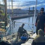 Matt Clarke and Homer Harbor crew assess vessel sunk vessel in Homer Harbor on Dec. 27, 2022. (Photo provided by Harbor crew)
