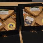 Two Cheese of the Month subscription boxes are filled with artisinal cheeses and sides on Friday, Jan. 6, 2023 at Lucys Market in Soldotna, Alaska. (Jake Dye/Peninsula Clarion)