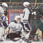 Soldotna goalie Jackson Purcell makes a save in front of defesenmen Aiden Burcham and Andrew Arthur and Colonys Jerad Hacker on Saturday, Jan. 7, 2023, at the Soldotna Regional Sports Complex in Soldotna, Alaska. (Photo by Jeff Helminiak/Peninsula Clarion)