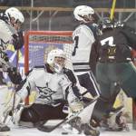 Soldotna goalie Jackson Purcell makes a save in front of defesenmen Aiden Burcham and Andrew Arthur and Colony's Jerad Hacker on Saturday, Jan. 7, 2023, at the Soldotna Regional Sports Complex in Soldotna, Alaska. (Photo by Jeff Helminiak/Peninsula Clarion)