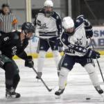 Colonys Robbie Yundt and Soldotnas Marshall DeRaeve battle for the puck Saturday, Jan. 7, 2023, at the Soldotna Regional Sports Complex in Soldotna, Alaska. (Photo by Jeff Helminiak/Peninsula Clarion)