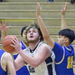 Nikiskis Drew Handley posts up on Kotzebues Bron Baldwin on Saturday, Jan. 14, 2023, at the 34th Annual Rus Hitchcock Nikiski Tip Off Tournament at Nikiski High School in Nikiski, Alaska. (Photo by Jeff Helminiak/Peninsula Clarion)