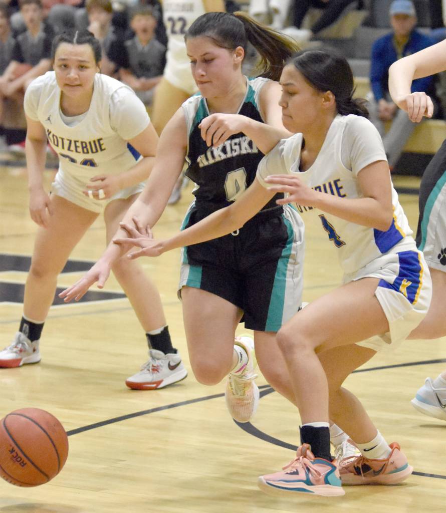 Nikiskis Savanna Stock and Kotzebues Zaina McConnell battle for the ball Saturday, Jan. 14, 2023, at the 34th Annual Rus Hitchcock Nikiski Tip Off Tournament at Nikiski High School in Nikiski, Alaska. (Photo by Jeff Helminiak/Peninsula Clarion)