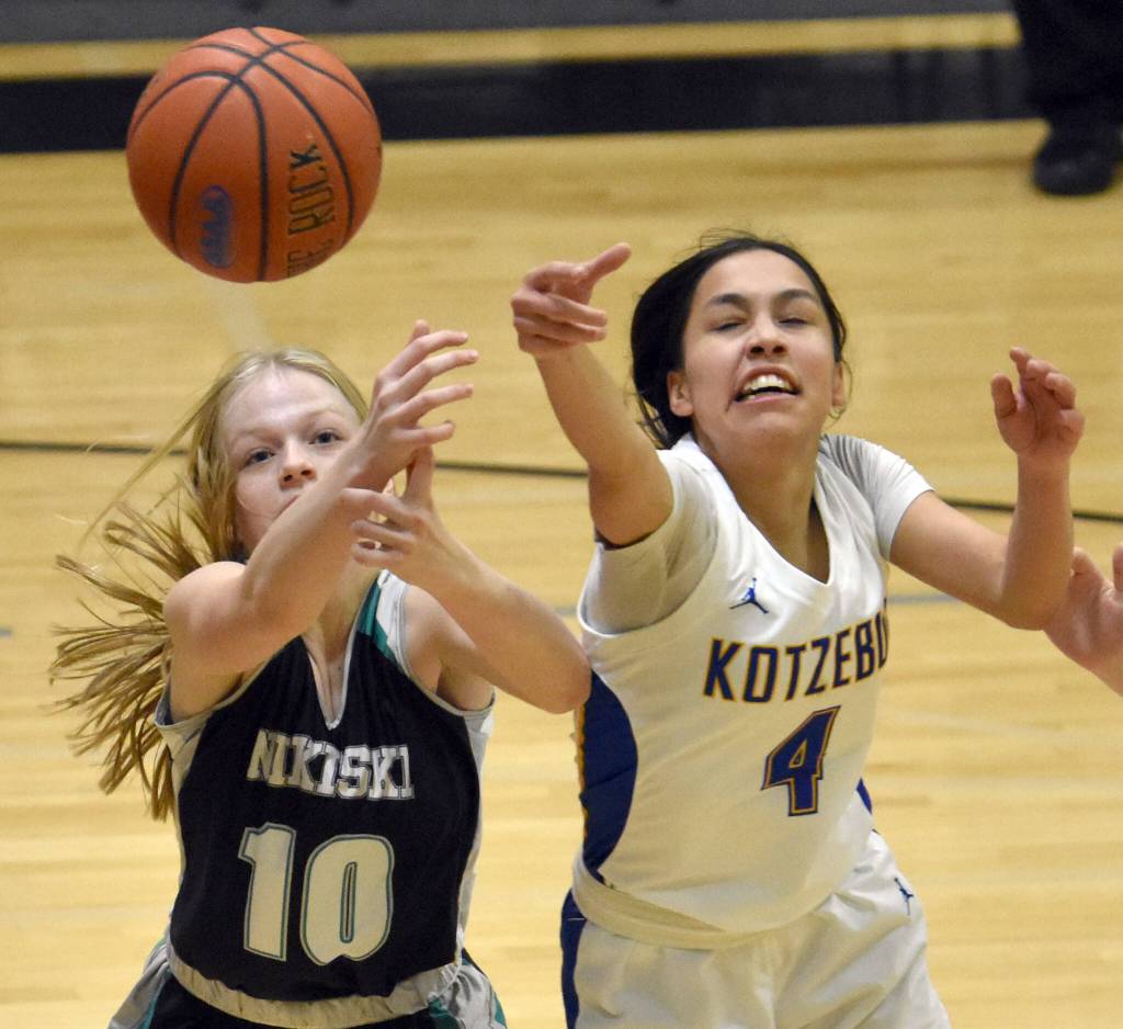 Nikiskis Avery White and Kotzebues Zaina McConnell battle for the ball Saturday, Jan. 14, 2023, at the 34th Annual Rus Hitchcock Nikiski Tip Off Tournament at Nikiski High School in Nikiski, Alaska. (Photo by Jeff Helminiak/Peninsula Clarion)