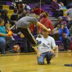 A junior athlete competing for the Kenaitze Indian Tribe performs the two-foot high kick during the Kahtnuhtana Hey Chiula NYO Invitational on Saturday, Jan. 14, 2023, at Kenai Middle School in Kenai, Alaska. (Jake Dye/Peninsula Clarion)