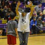 An official gives advice to a junior athlete competing for the Kenaitze Indian Tribe after the boy missed his first attempt at the 2-foot high kick during the Kahtnuhtana Hey Chiula NYO Invitational on Saturday, Jan. 14, 2023, at Kenai Middle School in Kenai, Alaska. (Jake Dye/Peninsula Clarion)