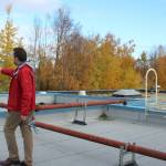 Soldotna Elementary School Principal Dr. Austin Stevenson walks amid natural gas pipes anchored to the outside of school on Friday, Sept. 30, 2022 in Soldotna, Alaska.The reconstruction of Soldotna Elementary School, expected to cost $21.5 million, would involve tearing down the existing structure and building a new two-story structure closer to Binkley Street. (Ashlyn OHara/Peninsula Clarion)
