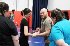Soldotna Police Chief Gene Meek leads attendees in exercises during a Toss A Cop event at the All American Training Center on Saturday, Jan. 21, 2023, in Soldotna, Alaska. (Ashlyn OHara/Peninsula Clarion)