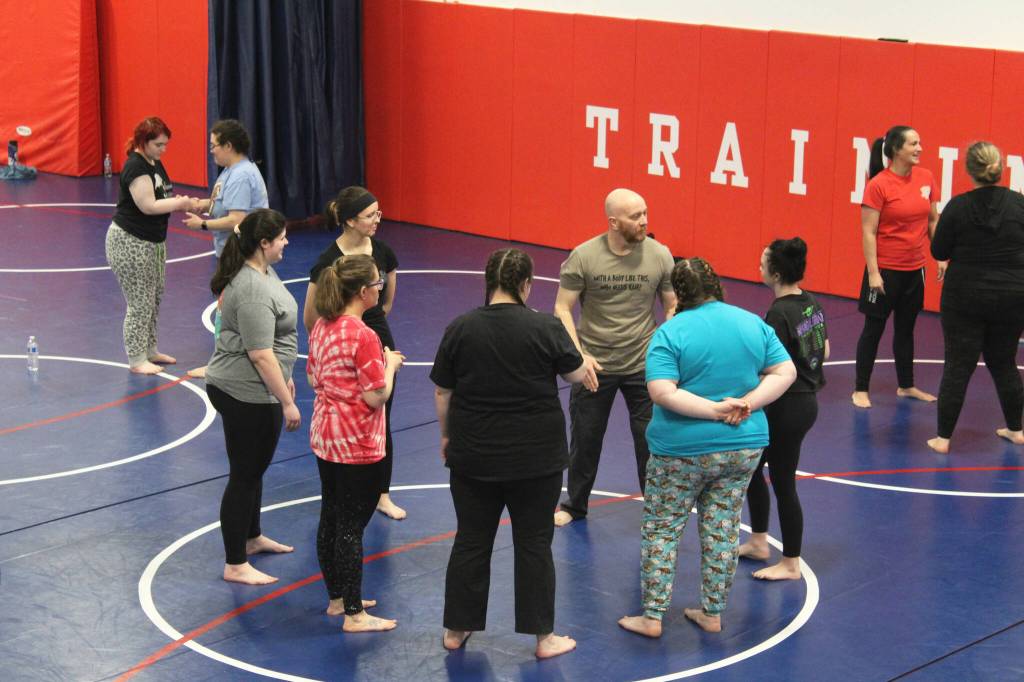 Soldotna Police Chief Gene Meek leads attendees in exercises during a Toss A Cop event at the All American Training Center on Saturday, Jan. 21, 2023, in Soldotna, Alaska. (Ashlyn OHara/Peninsula Clarion)