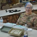 A volunteer sits ready to check in visitors to the Kenai United Methodist Food Pantry in Kenai, Alaska, on Monday, Jan. 23, 2022. (Jake Dye/Peninsula Clarion)