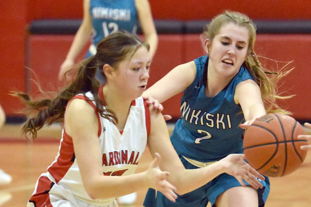 Kenai Centrals Emilee Wilson and Nikiskis Shelby Burman battle for the ball Tuesday, jan. 31, 2023, at Kenai Central High School in Kenai, Alaska. (Photo by Jeff Helminiak/Peninsula Clarion)
