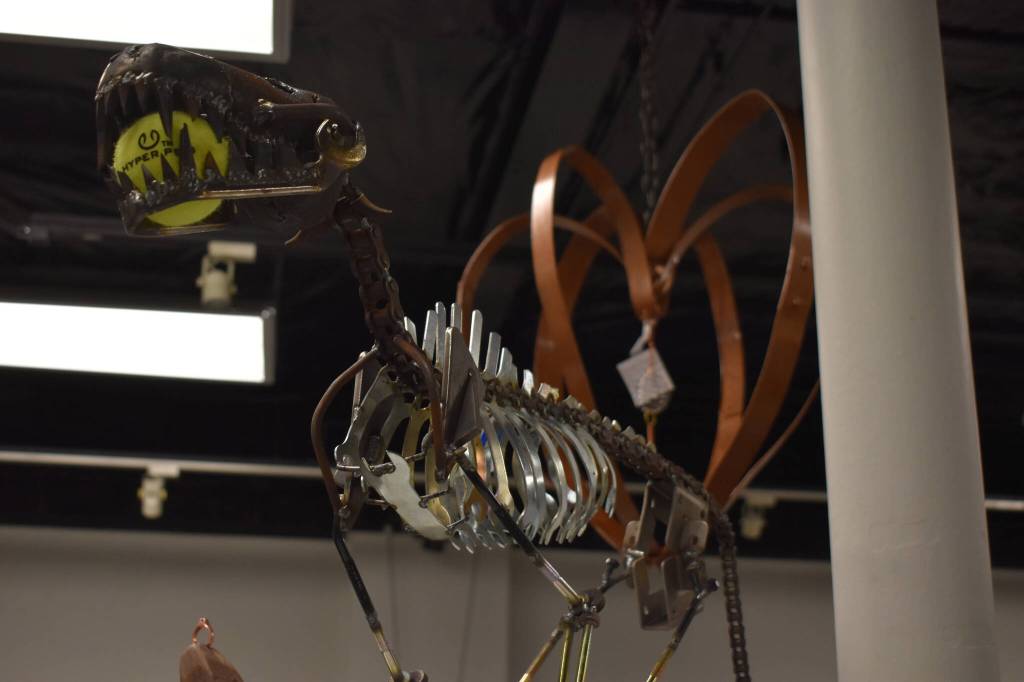 A metal dog created by Dave Emery stands tall, clutching a tennis ball in its mouth Tuesday, Jan. 31, 2023, at the Kenai Art Center, in Kenai, Alaska, as part of Metalwork & Play. (Jake Dye/Peninsula Clarion)
