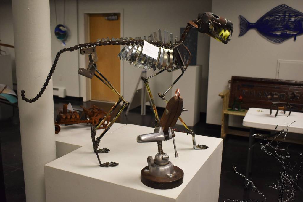 A metal dog created by Dave Emery stands alongside other metal creations on Tuesday, Jan. 31, 2023, at the Kenai Art Center, in Kenai, Alaska, as part of Metalwork & Play. (Jake Dye/Peninsula Clarion)