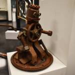 A small metal man takes a seat on a railroad track in this sculpture by Jacob Nabholz seen Tuesday, Jan. 31, 2023, at the Kenai Art Center, in Kenai, Alaska, as part of Metalwork & Play. (Jake Dye/Peninsula Clarion)