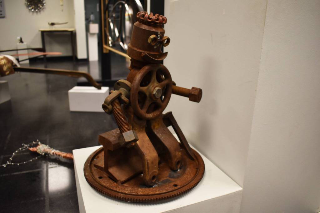 A small metal man takes a seat on a railroad track in this sculpture by Jacob Nabholz seen Tuesday, Jan. 31, 2023, at the Kenai Art Center, in Kenai, Alaska, as part of Metalwork & Play. (Jake Dye/Peninsula Clarion)