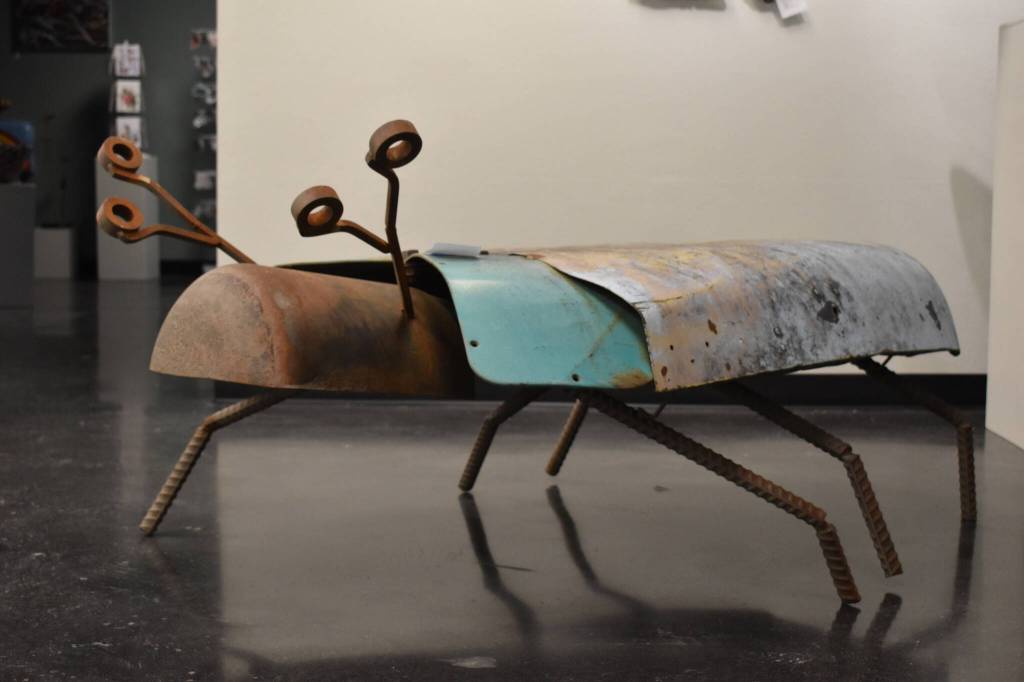 A large metal beetle sculpted by Jacob Nabholz stands on legs made of rebar Tuesday, Jan. 31, 2023, at the Kenai Art Center, in Kenai, Alaska, as part of Metalwork & Play. (Jake Dye/Peninsula Clarion)