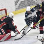 Kenai Central goalie Evyn Witts makes a save on Soldotnas Ezekiel Miller as Kenais Reagan Graves and Logan Mese defend Friday, Jan. 27, 2023, at the Soldotna Regional Sports Complex in Soldotna, Alaska. (Photo by Jeff Helminiak/Peninsula Clarion)