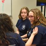 Lyndzi Gaucin describes her reasoning to her teammates, Leihla Harrison and Emma Knowles as they discuss their response to a question during Kenai Peninsula Borough School District High School Battle of the Books Final on Tuesday, Feb. 7, 2023 at Soldotna High School in Soldotna, Alaska. (Jake Dye/Peninsula Clarion)