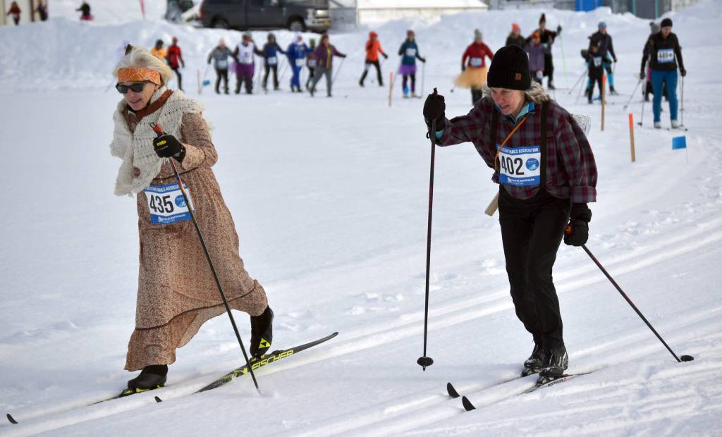 Gigi Banas and Sue Seggerman ski at the 19th annual Ski For Women on Sunday, Feb. 12, 2023, at Tsalteshi Trails just outside of Soldotna, Alaska. The two, with Banas as Grandma and Seggerman as the Woodcutter, were part of the winning costume of Little Red Riding Hood and the Big Bad Wolf. Not pictured, Leslie Boyd was Little Red Riding Hood and Sara Mahood was the Wolf. (Photo by Jeff Helminiak/Peninsula Clarion)
