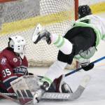 Carson Triggs of the Kenai River Brown Bears scores the game-winning goal in overtime against Fairbanks Ice Dogs goalie Kayden Hargraves on Saturday, Feb. 18, 2023, at the Soldotna Regional Sports Complex in Soldotna, Alaska. (Photo by Jeff Helminiak/Peninsula Clarion)