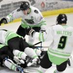 The Kenai River Brown Bears pile on Carson Triggs after he scored the game-winning goal in overtime against the Fairbanks Ice Dogs on Saturday, Feb. 18, 2023, at the Soldotna Regional Sports Complex in Soldotna, Alaska. (Photo by Jeff Helminiak/Peninsula Clarion)