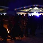 Attendees gather around fires or the stage during Frozen RiverFest on Saturday, Feb. 18, 2023 at Soldotna Creek Park in Soldotna, Alaska. (Jake Dye/Peninsula Clarion)