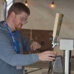 A brewer from Arkose Brewery fills a tasting cup during Frozen RiverFest on Saturday, Feb. 18, 2023 at Soldotna Creek Park in Soldotna, Alaska. (Jake Dye/Peninsula Clarion)