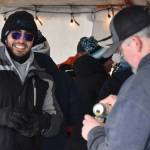 An attendee gets a drink from HooDoo Brewing Company during Frozen RiverFest on Saturday, Feb. 18, 2023 at Soldotna Creek Park in Soldotna, Alaska. (Jake Dye/Peninsula Clarion)