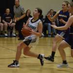 Nikiski's Ember Nelson looks to shoot, closely pursued by Homer's Minadora Reutov and Hannah Stonorov during a basketball game on Tuesday Feb. 21, 2023, at Nikiski Middle/High School in Nikiski, Alaska. (Jake Dye/Peninsula Clarion)