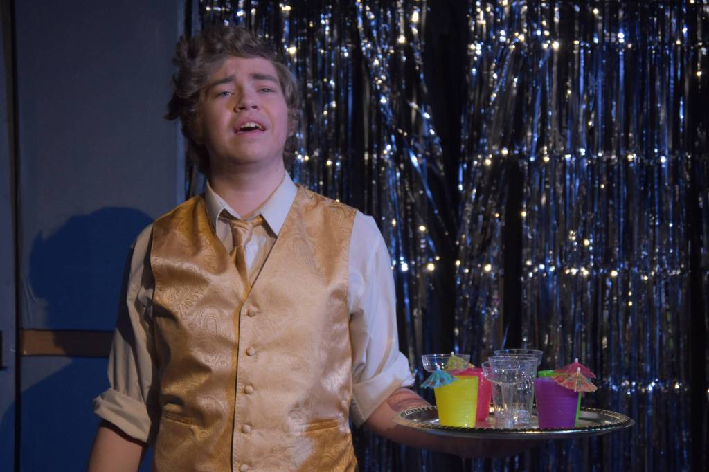 Josiah Burton delivers a solo as Chad during a rehersal of Disaster! on Tuesday, Feb. 21, 2023, at the Kenai Performers Theater in Soldotna, Alaska. (Jake Dye/Peninsula Clarion)