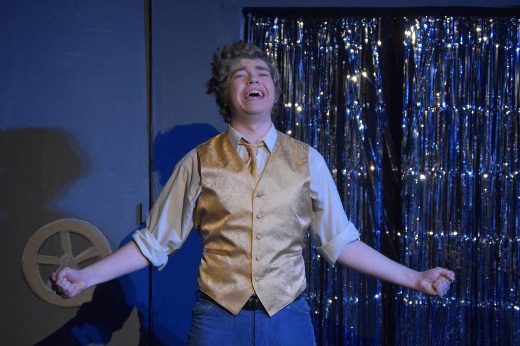 Josiah Burton delivers a solo as Chad during a rehersal of Disaster! on Tuesday, Feb. 21, 2023, at the Kenai Performers Theater in Soldotna, Alaska. (Jake Dye/Peninsula Clarion)