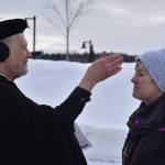 Father Rick Miles applies ashes to Pastor Karen Martin Tichenors forehead as they prepare for Ashes to Go! on Wednesday; Feb. 22; 2023 at Soldotna Creek Park in Soldotna; Alaska. (Jake Dye/Peninsula Clarion)