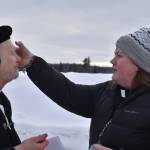 Father Rick Miles receives ashes from Pastor Meredith Harber as they prepare for Ashes to Go! on Wednesday; Feb. 22; 2023 at Soldotna Creek Park in Soldotna; Alaska. (Jake Dye/Peninsula Clarion)