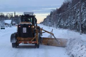 A City of Kenai grader moves snow from a roadway on Wednesday, Dec. 7, 2022 in Kenai, Alaska. (Ashlyn OHara/Peninsula Clarion)